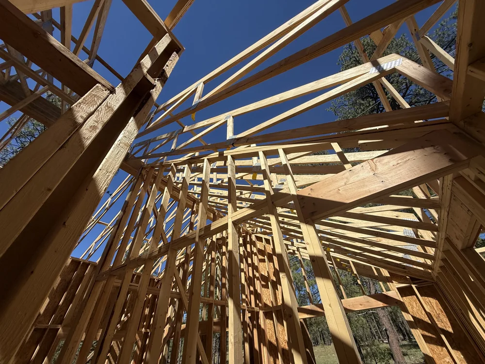 Wide view of roof trusses and wall framing at the Munds Park cottage